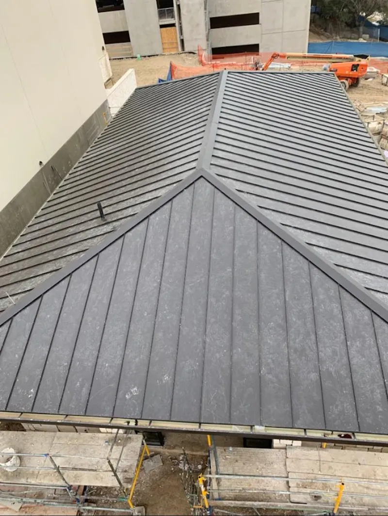 Commercial metal roof construction with crane equipment in Marana