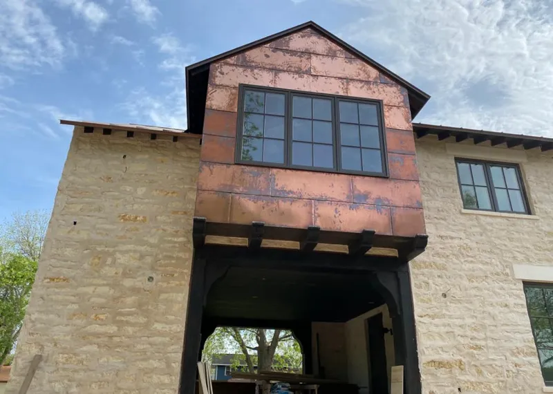 Copper metal panel facade on a stone building for Roof Repair in Marana